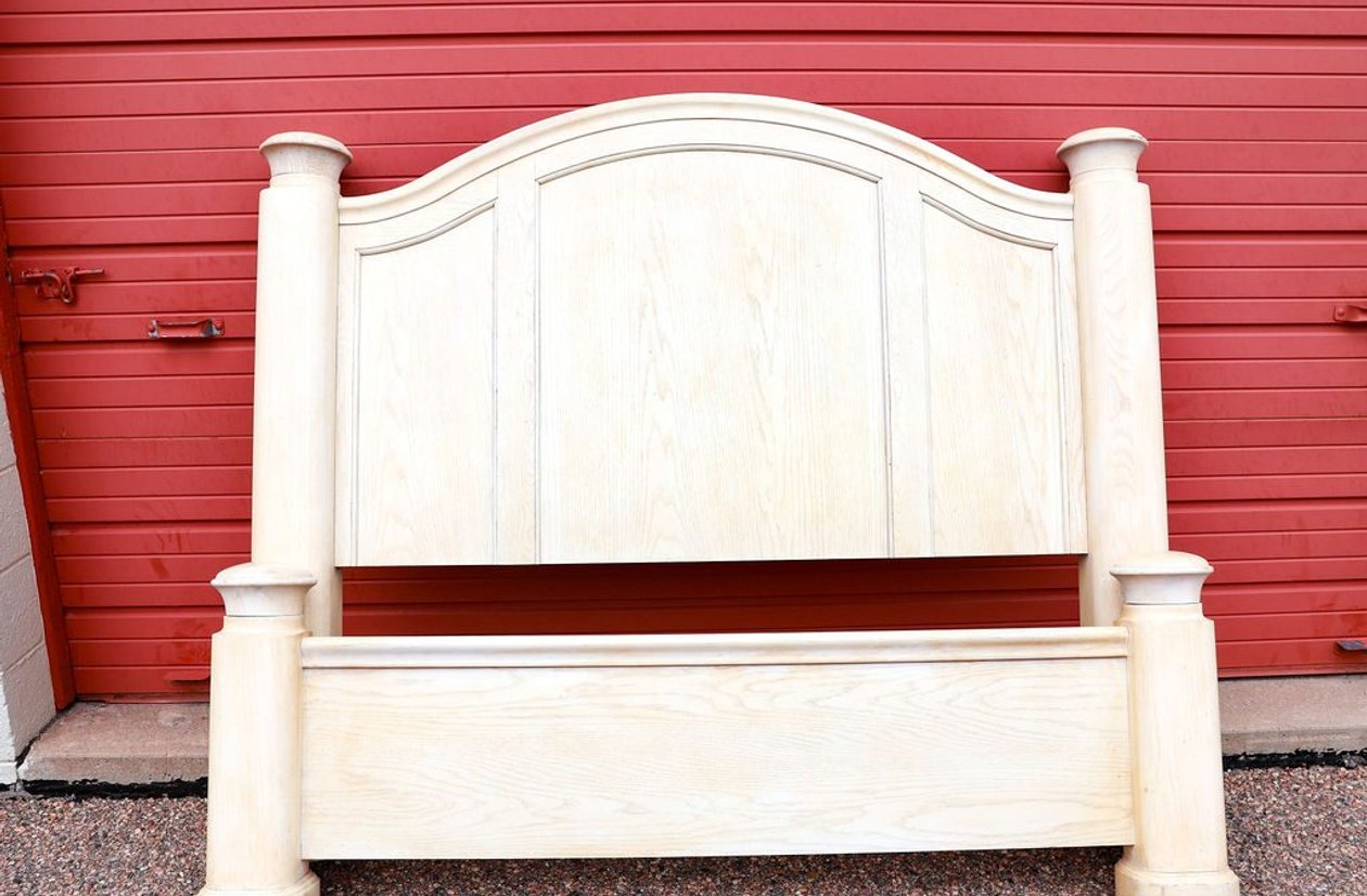 Cream king size arched headboard with four column posts and routed panel molding