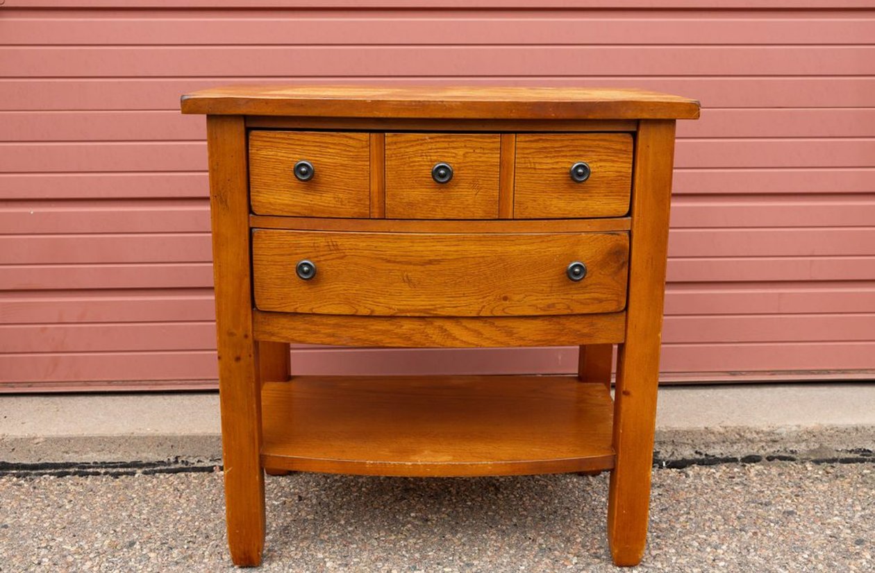 Mission style honey oak end table with 4 drawers and open lower shelf