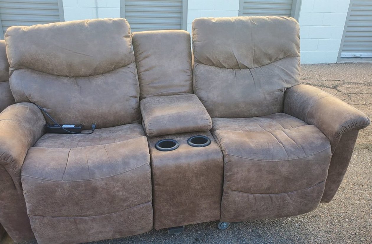 Brown microfiber power reclining loveseat with center console cupholders and built-in power outlet