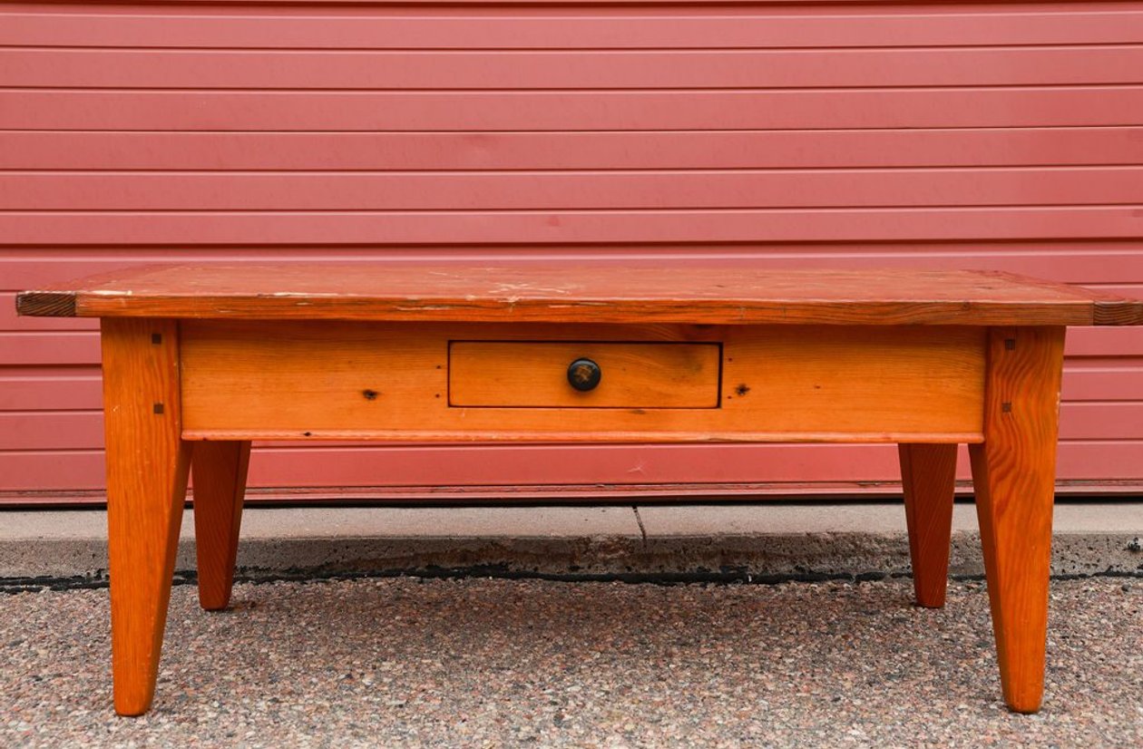 Rustic solid pine coffee table with single center drawer and tapered farmhouse legs